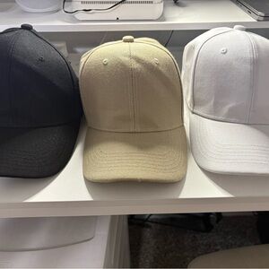 Black, Beige, and White Baseball Caps